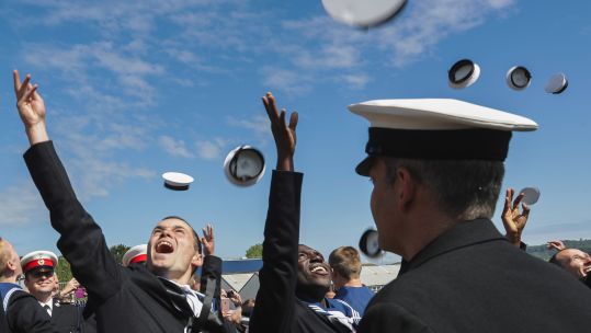Cover image: A library image of junior ratings celebrating passing out at HMS Raleigh (Picture: Royal Navy).
