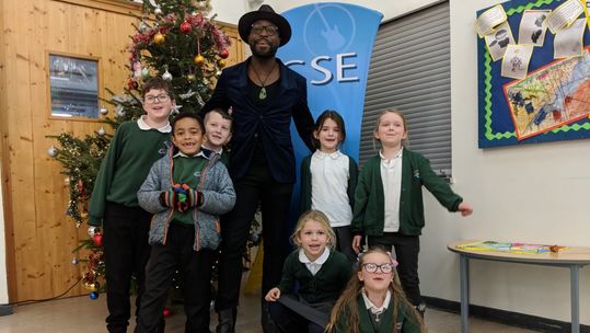 Kevin Davy White with children at Attenborough School, Germany