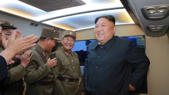 Cover Image: Kim Jong Un laughing after a missile launch earlier this year (Picture: KCNA).