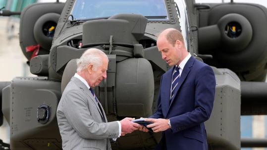 King Charles III officially hands over the role of Colonel-in-Chief of the Army Air Corps to the Prince of Wales, in front of an Apache helicopter 130524 