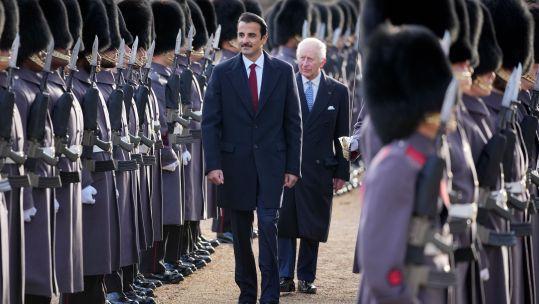 King Charles and the Emir of Qatar inspect a guard of honour during a ceremonial welcome
