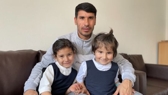 Kouchai Zaki, a former interpreter for the British military in Afghanistan, alongside his family in Scotland