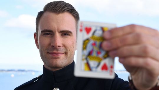 LCpl Richard Jones Magician Queen Of Hearts Card ID TC23PT Credit PA Images and Alamy Stock Photo