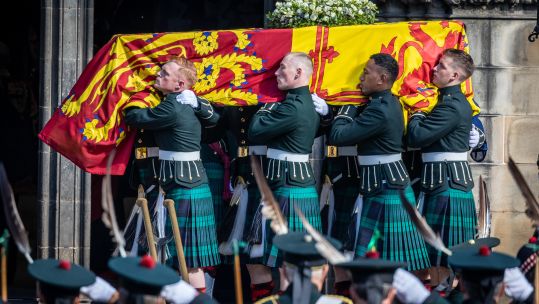 Her Majesty Queen Elizabeth II's coffin carried by members of the Royal Regiment of Scotland into St Giles' Cathedral