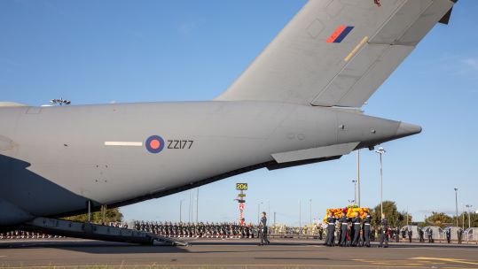 Pallbearers from the Royal Air Force Regiment carry the coffin of Her Majesty Queen Elizabeth II into an awaiting C17 aircraft before the flight to RAF Northolt (Picture A/CPL Ciaran McFalls RAF / UK MOD Crown Copyright).