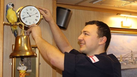 Lieutenant Ben Carver pictured in 2019 changing a clock on board HMS Sutherland CREDIT Royal Navy