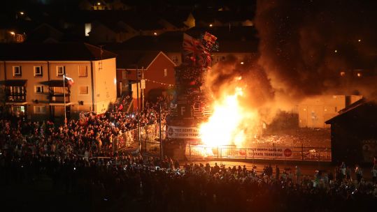 The main bonfire burns in the Bogside area of Londonderry in Northern Ireland, to mark the Catholic Feast of the Assumption (Picture: PA).