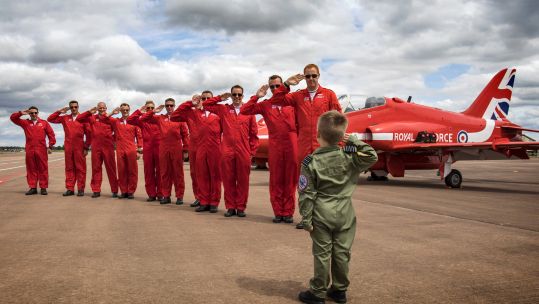 five year old Jacob salutes red arrows