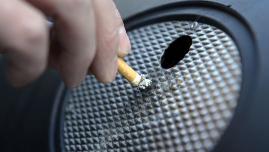Man stubbing out a cigarette (Picture: PA).