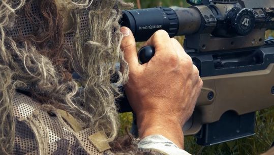 A marine opens bolt of his L96 .338 sniper rifle