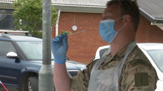 Member of 29 Commando Regiment shows how to use self testing kit at CORONAVIRUS COVID19 mobile testing unit in Bude 
