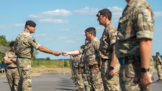 Cover image: Personnel from 16 Signal Regiment receive their badge (Picture: MOD).