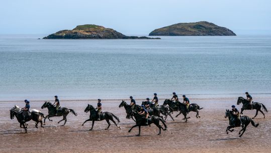 Members of the Household Cavalry, Blues and Royals, exercise their horses along the sands and in the sea at Yellowcraig Beach near North Berwick, East Lothian (Picture: PA NO REUSE).
