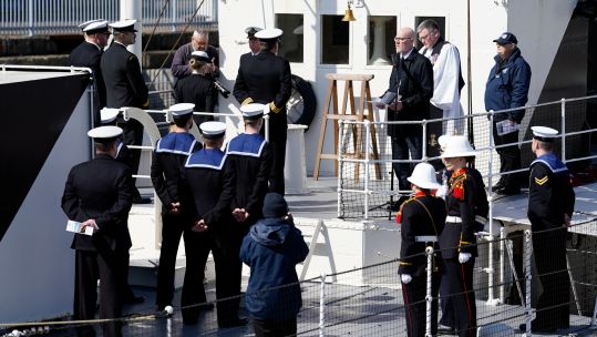 Members of the Royal Navy, Royal New Zealand Navy and Royal Australian Navy take part in an Anzac Day service of remembrance on board HMS M.33, the sole-surviving ship from the Gallipoli campaign 250424 CREDIT PA