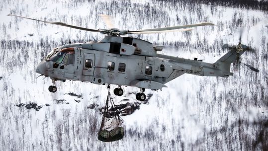 The underslung load being hauled by the Merlin contains three years' supply of firewood