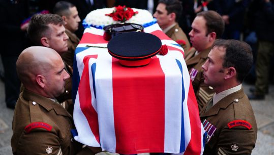 Military pallbearers carry Dennis Hutchings' coffin at his funeral