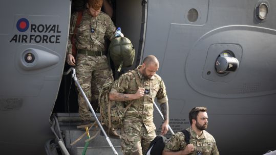 Military personnel departing from a RAF C-17 aircraft after landing at RAF Brize Norton after leaving Afghanistan having helped the UK's evacuation from Kabul airport
