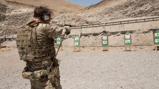 Military personnel from Estonia and Britain taking part in a 9mm shooting competition in Iraq