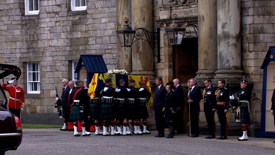 Military personnel from the Royal Regiment of Scotland carrying Queen Elizabeth II's coffin into Holyrood Palace