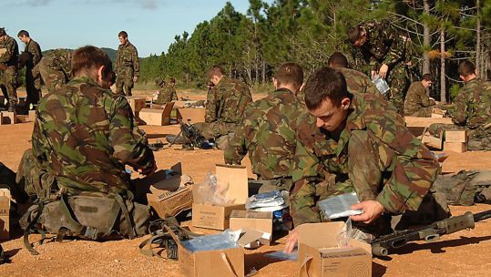 Military ration packs being used by personnel. Unused packs are being donated to FareShare to provide over 170000 meals for those in need
