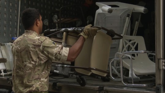 Lance Corporal Akuila Tuimereke loads a van full of Zimmer frames bound for Moldova. 