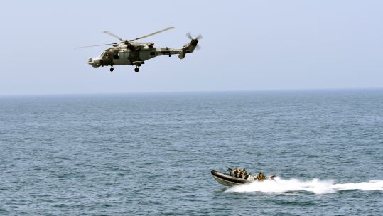 Montrose's Wildcat provides cover for the boarding team DATE UNKNOWN sent on 220321 CREDIT Royal Navy