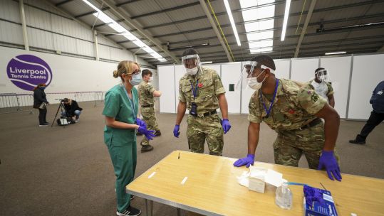 Cover image: Soldiers alongside NHS staff prepare for the start of mass testing at Liverpool Tennis Centre (Picture: PA).