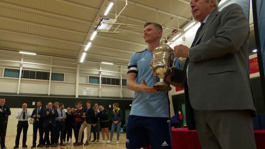 Men's RAF team captain Corporal Scott Perry accepts the team trophy