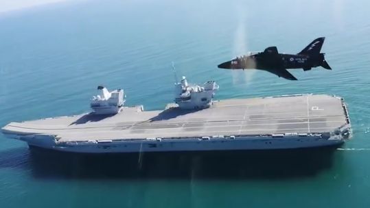 Navy Hawk jets fly over HMS Prince of Wales 