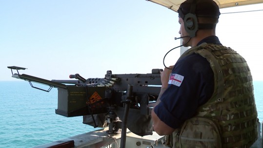 Sailor with heavy machine gun on HMS Blyth