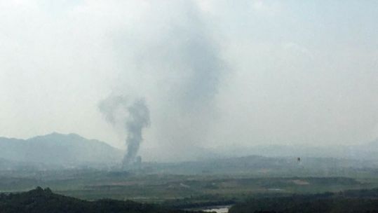 Cover image: Smoke rises from the inter-Korean office in Kaesong following the demolition (Picture: Yonhap/PA).