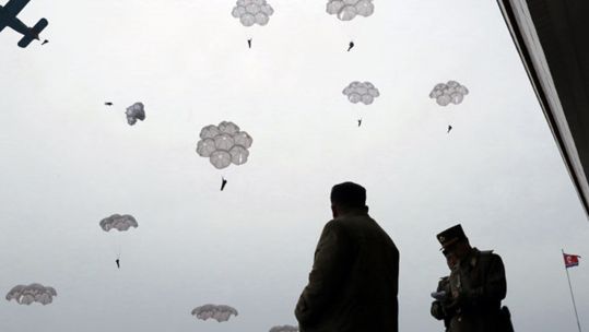 North Korean leader Kim Jong-un oversees airbourne landing training with sharpshooters of the North's Air and Anti-Aircraft Force in 2019 (Picture: KCNA via PA.