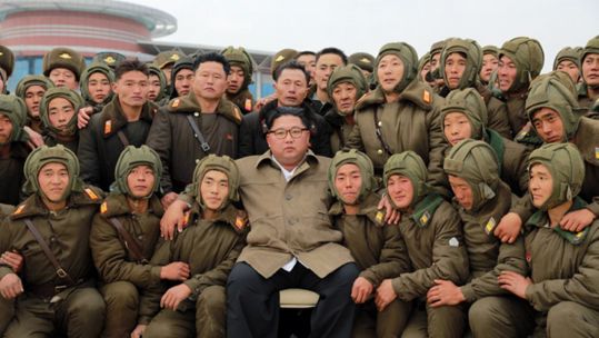 North Korean leader Kim Jong-un poses for a group photo with sharpshooters of the North's Air and Anti-Aircraft Force (Picture: KCNA via PA).