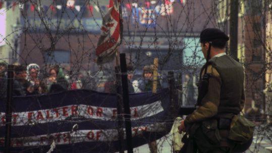 On duty beside barbed wire barricades on the Falls Road, Belfast, 1969 (Picture: PA images).