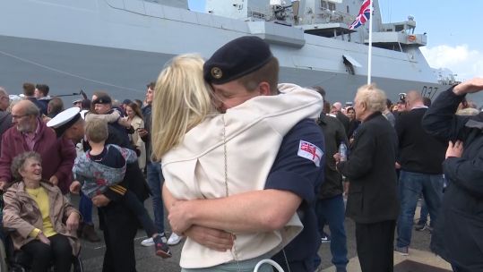 One of HMS Duncan's company embraces a loved one after returning home to Portsmouth.