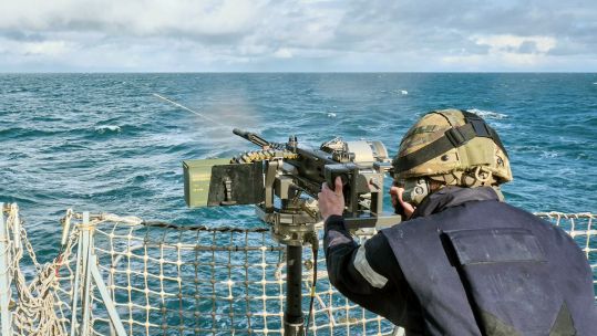 One of Portlands gunners fires the 50 cal on the existing mount during tests on HMS Argyll