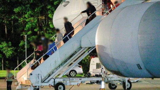 People evacuated from Kabul disembark from an RAF Voyager at RAF Brize Norton 