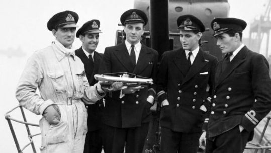 The officers of HMS Seraph (P219) the S-class submarine used for Operation Mincemeat with a model of their sub in December 1943 (Picture: Pictorial Press Ltd / Alamy).