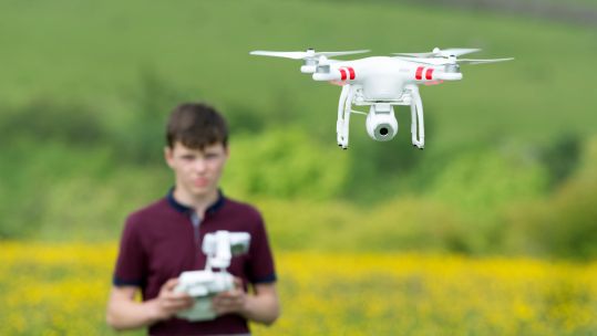 Operating a quadcopter drone in UK countryside Image ID GCYRNR 040616 CREDIT Alamy Stock Photo