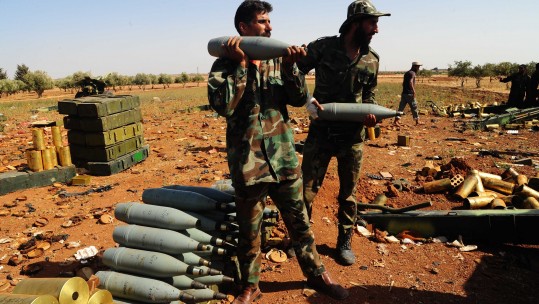  Syrian soldiers load artillery shells in Kahil town, Daraa province, Syria, on July 3, 2018. The Syrian army captured Kahil town from the rebels on Tuesday and is moving toward the town of Saida as part of a wide-scale offensive against the ultra-radical groups, which rejected a reconciliation deal with the government in Daraa. (Xinhua/Ammar Safarjalani)