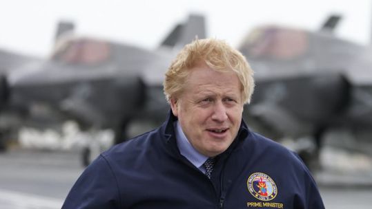 PM Boris Johnson looks on as he stands on the deck of aircraft carrier HMS Queen Elizabeth in Portsmouth 210521 CREDIT Number 10,FLICKR
