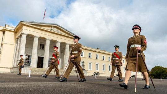 Soldier cadets practice marching with pace sticks at Sandhurst military academy