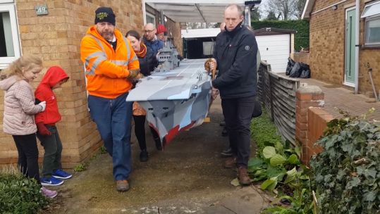 People move the 17 foot aircraft carrier model in Doncaster.