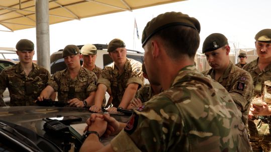 Soldiers by a vehicle