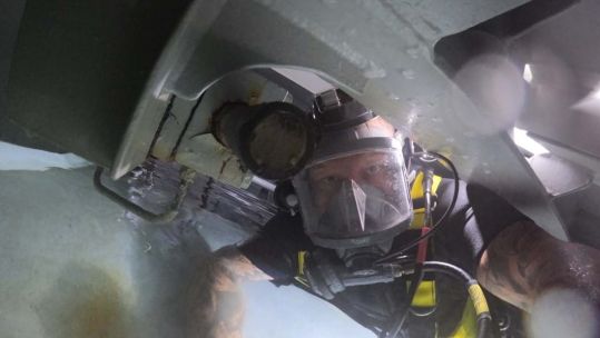 	Personnel from HMS Audacious completing underwater repairs on the submarine which saw them given The Churchill Award 