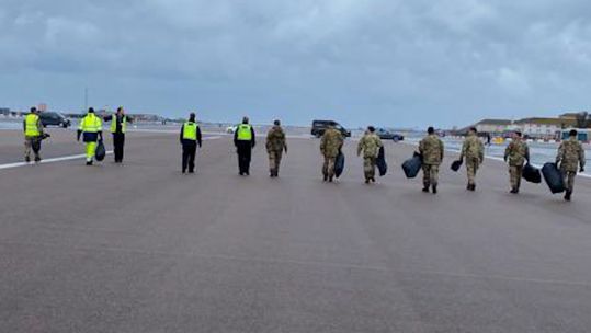 Personnel help to clear sea debris from runway at RAF Gibraltar (Picture: RAF Gibraltar).