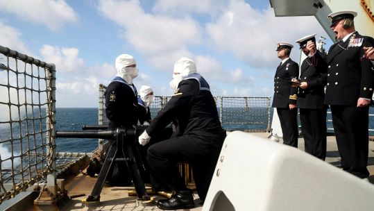 Personnel on HMS Queen Elizabeth positioned during a gun salute to mark the passing of Her Majesty Queen Elizabeth II (Picture: MOD).