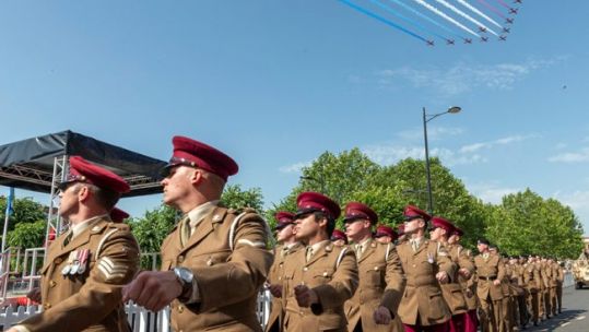 Personnel parade on Salisbury Armed Forces Day under Red Arrows flypast