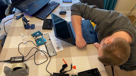 Phil Macrae former naval engineer refurbishing computers for Children in 19022021 CREDIT BFBS