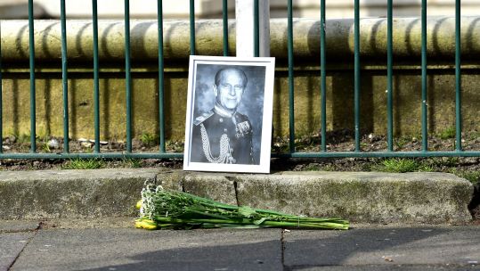 Photograph of Prince Philip and flowers left at Brighton War Memorial after the announcement of his death 090421 CREDIT ALAMY
